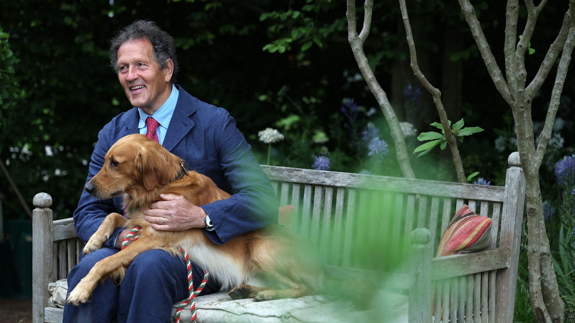 picture of Monty and dog Ned sitting on bench in Chelsea Flower Show