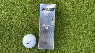 A sleeve of Mizuno RB Tour golf balls, Mizuno RB Tour golf ball, mizuno golf ball with grass background