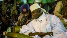 Incumbent Gambian President Yahya Jammeh listens to one of his aides in Banjul on November 29, 2016, during the closing rally of the electoral campaign of the Alliance for Patriotic Reorienta