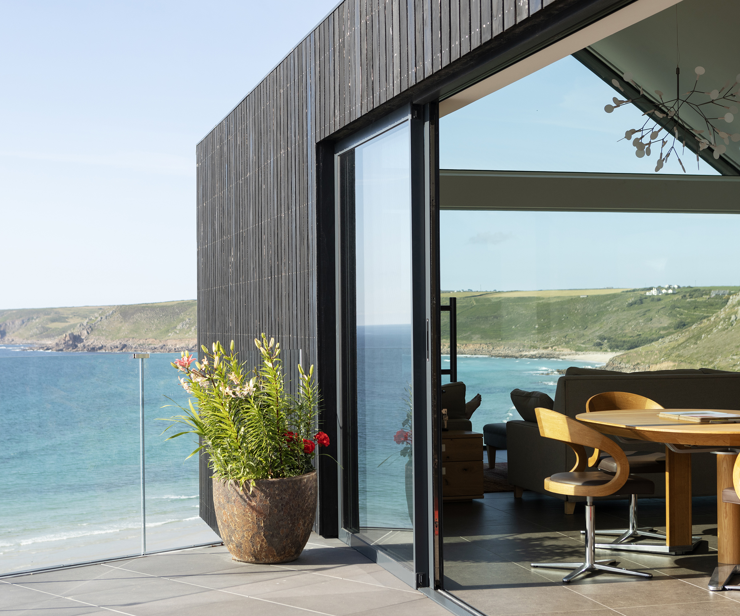 Sliding glass doors on a sunny terrace with sea views