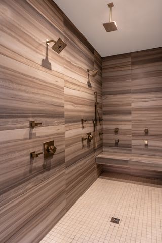 shower with benches, gold fixtures and fittings brown, wood effect scheme