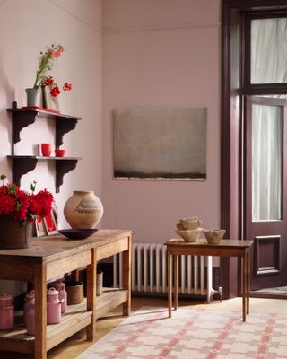 Utility area with walls painted in mauve and woodwork in deep red-brown