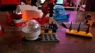 The parts of Lego Sonic vs Dr. Eggman's Death Egg Robot laid out on a wooden coffee table