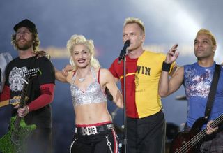 Tom Dumont, Gwen Stefani and Tony Kanal of No Doubt perform with Sting during halftime of Super Bowl XXXVII between the Tampa Bay Buccaneers and the Oakland Raiders on January 26, 2003 at Qualcomm Stadium in San Diego, California. The Bucs beat the Raiders 48-21.