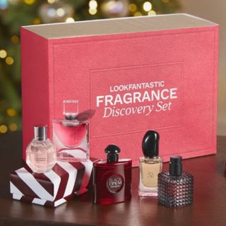 A press shot of the LOOKFANTASTIC Festive Fragrance Discovery Set For Her in front of a Christmas tree