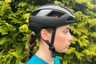 Female cyclist wearing the Trek Velocis MIPS road bike helmet