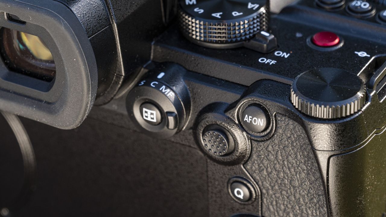 Panasonic Lumix S5 II camera on a table with closeup of the autofocus joystick