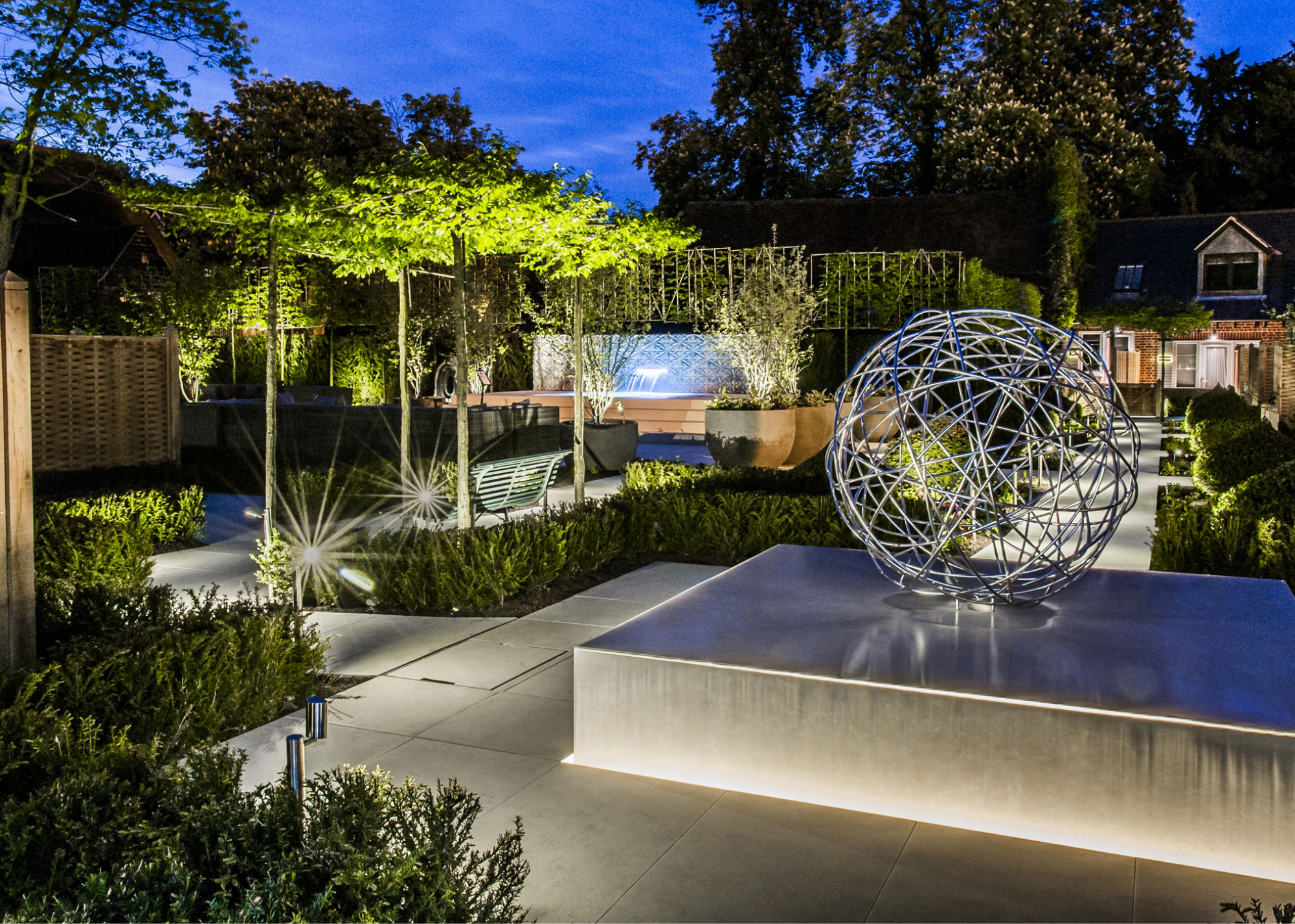 parasol pleached trees with lighting in modern garden