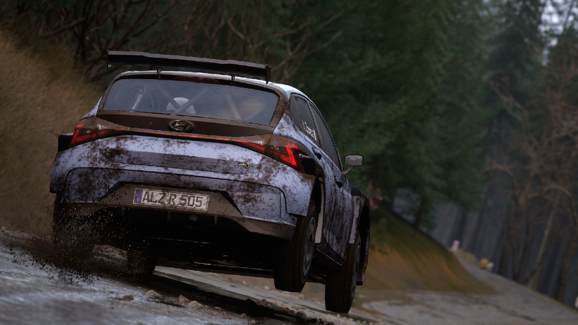 A car takes off down a muddy road, spraying dirt, in Assetto Corsa Rally.