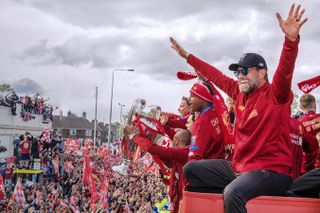 Liverpool manager Jurgen Klopp waves to fans during the bus parade after the Reds' Champions League final win over Tottenham in June 2019.