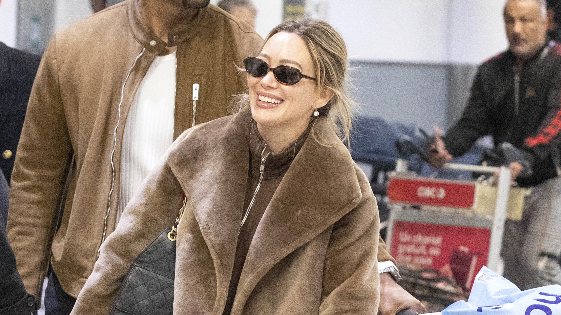 Hilary Duff wearing a brown outfit at the airport in Toronto