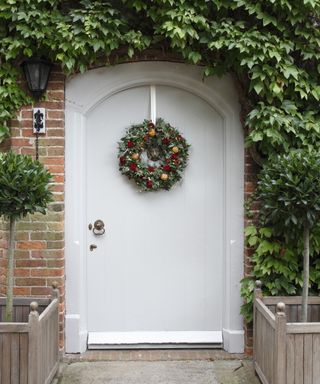 White front door with Christmas wreath