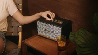 Cyber Monday Marshall speaker and headphones deals: Person adjusting the volume on a Marshall Stanmore II speaker