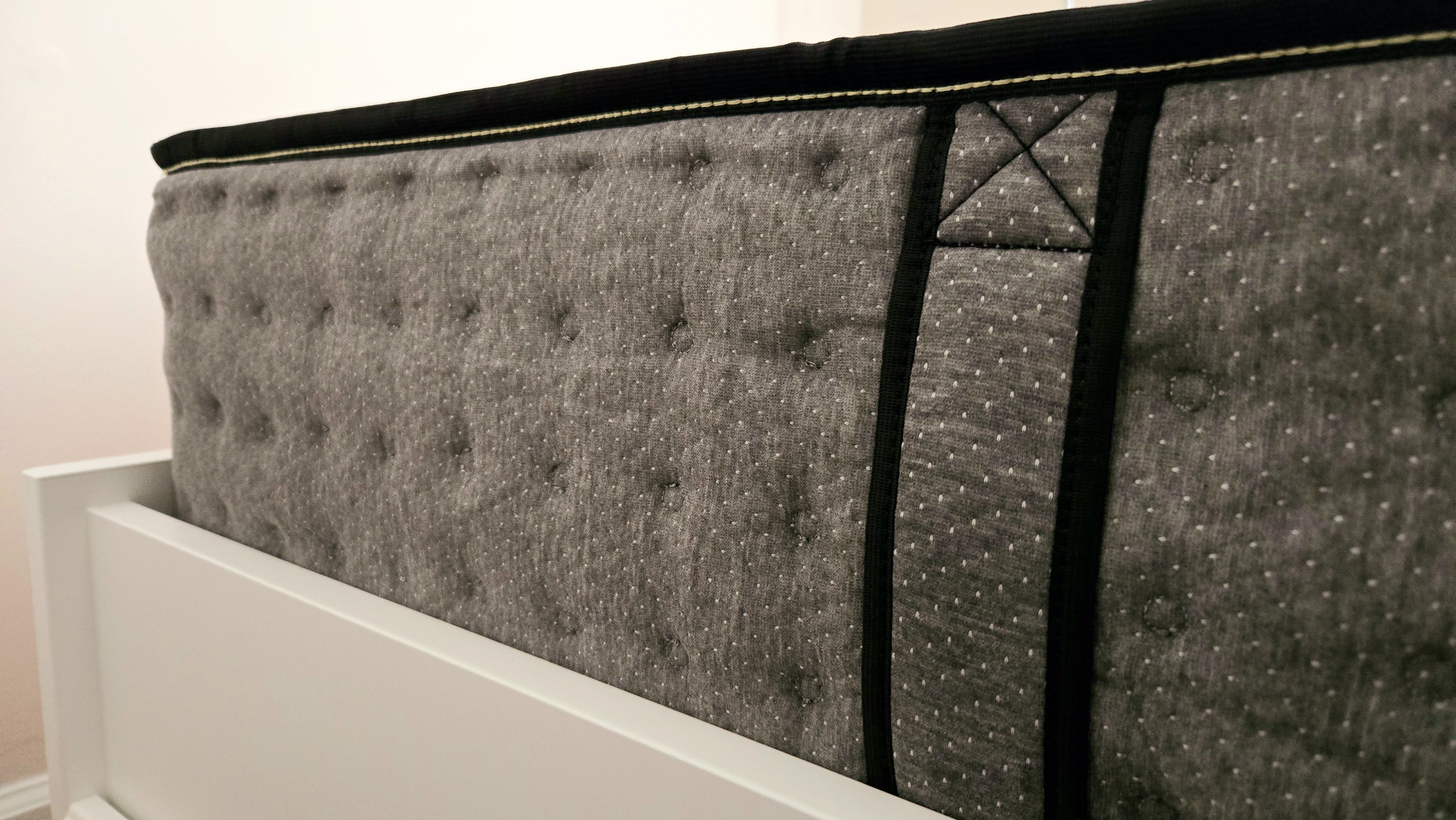 Closeup of the Siena Premier Hybrid Mattress from the side, with one of the side carry handles in view