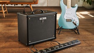 A Stratocaster sits next to one of Boss's Katana Gen 3 amplifiers
