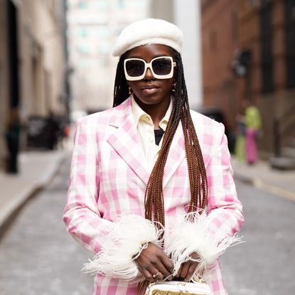 woman wearing plaid pink coat and white beret