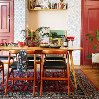 Christmas dining room with wooden table and chairs and rug