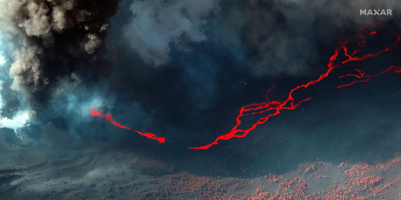 New photos of the Cumbre Vieja volcano on Spain's La Palma island taken on Oct. 14, 2021 show bright lava rivers from the continuing eruption.