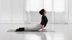 a woman in cobra pose during a yoga workout