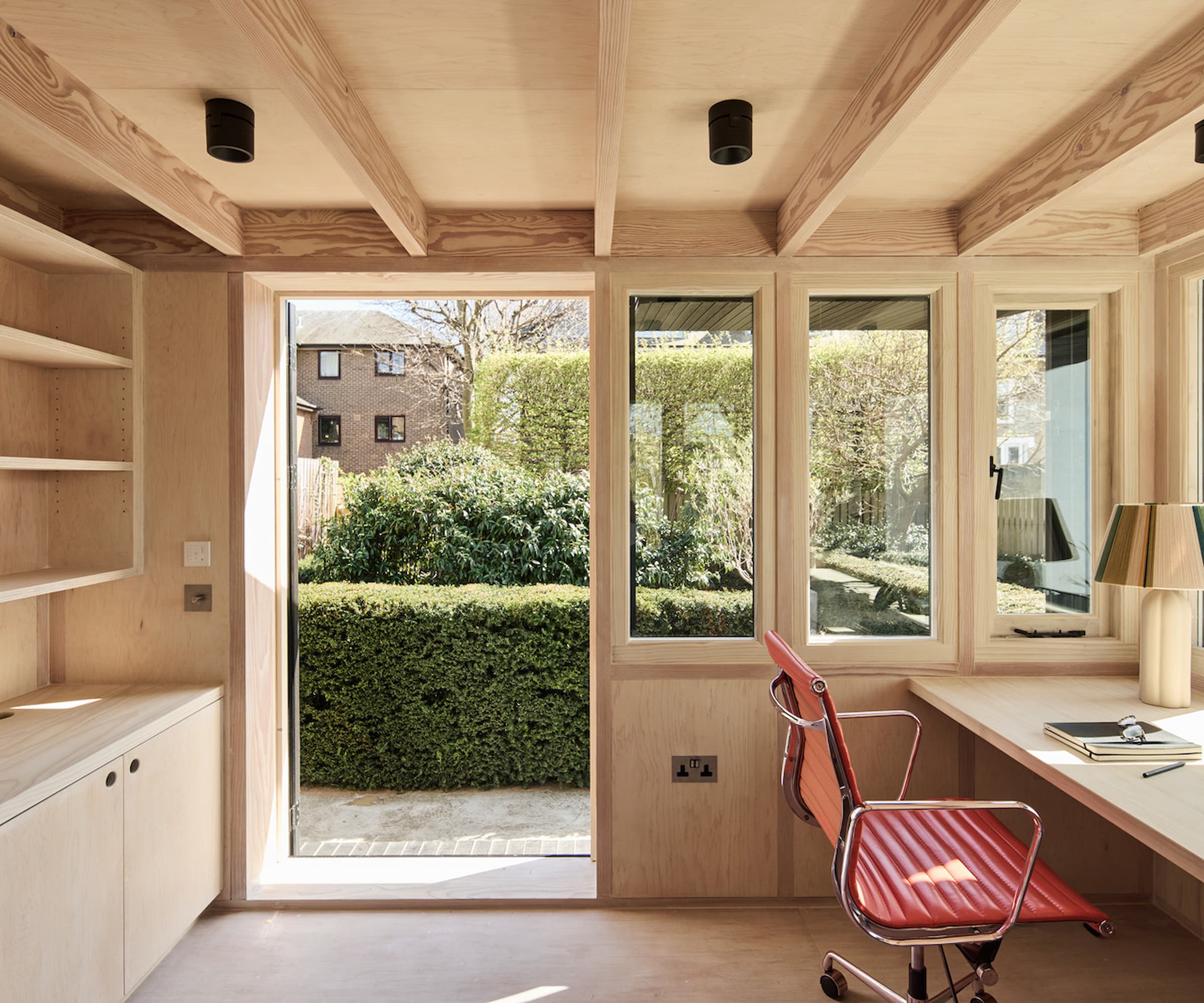 A timber garden house with a seating area