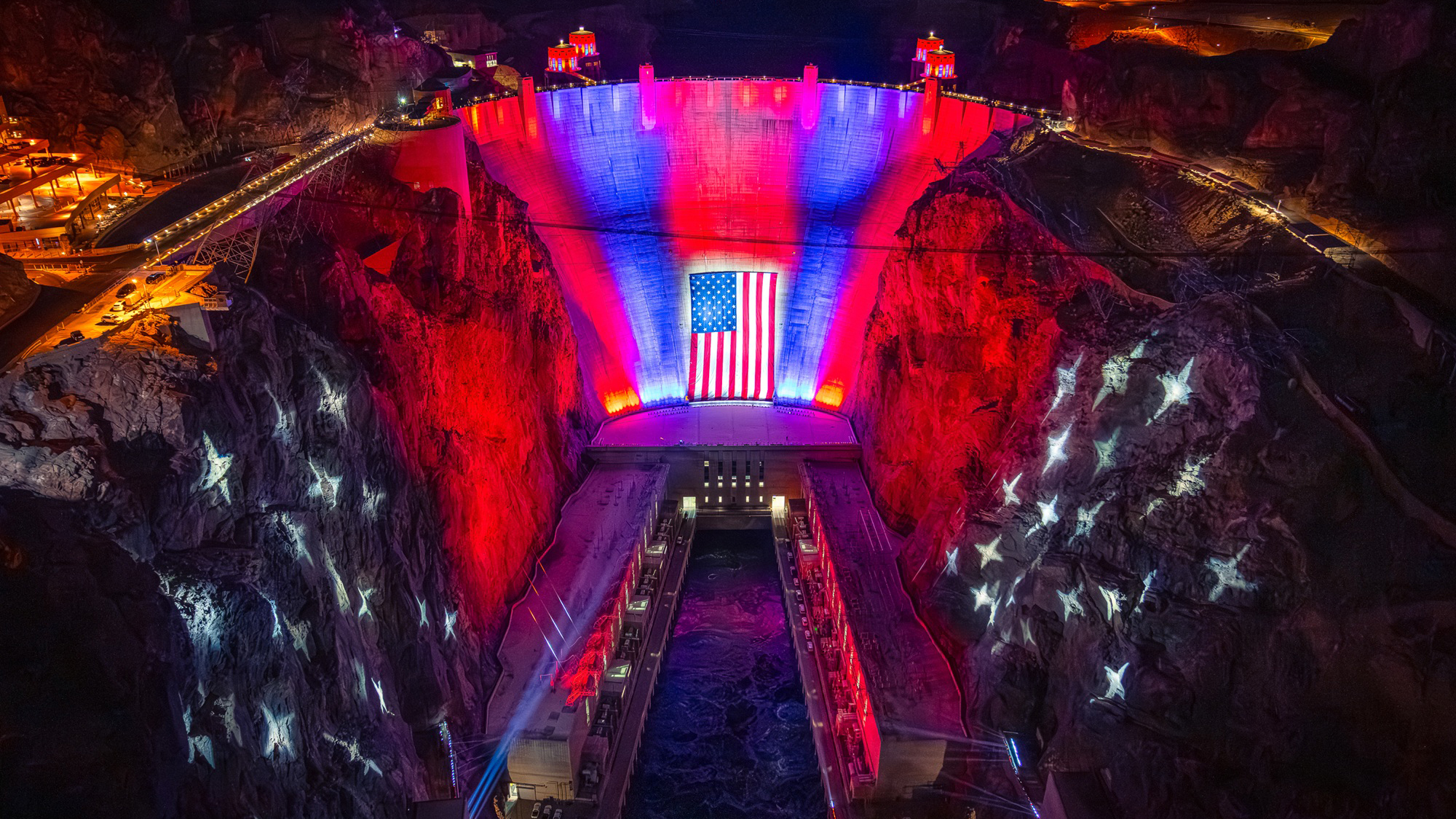 The Hoover Dam lit up in red, white, and blue with the American flag for the 250th anniversary. 