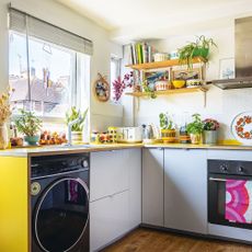 retro style kitchen with grey and yellow kitchen units and open shelves