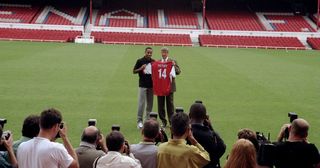Thierry Henry signs for Arsenal Football Club and is presented to the media by his new manager Arsene Wenger during a photo-call held at Highbury in London, England.