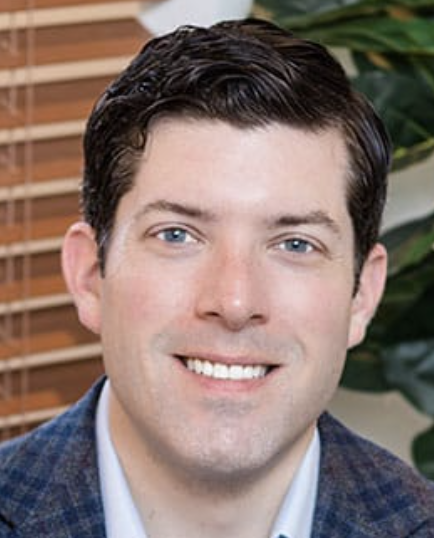 a white man in a blue jacket