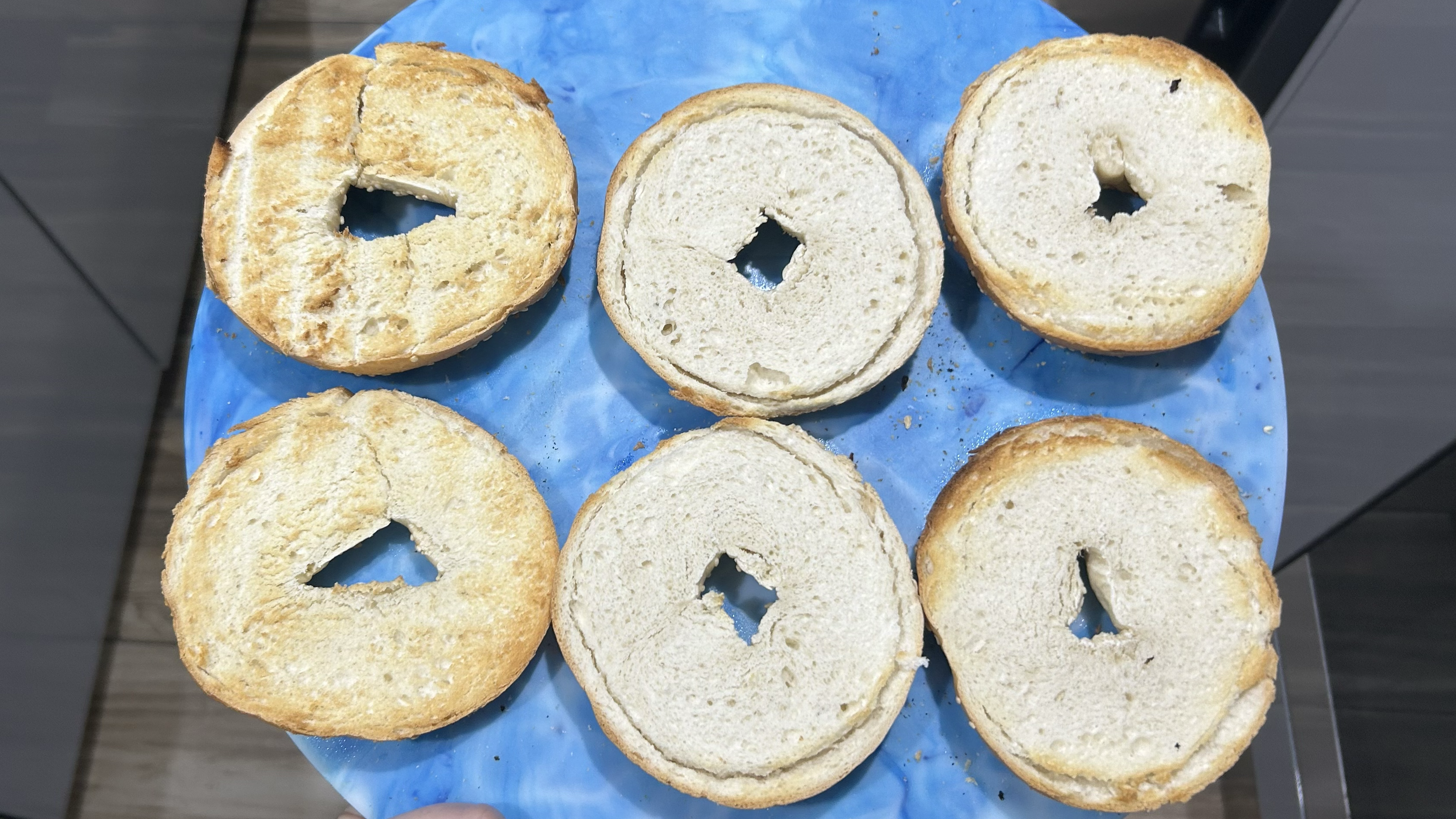 Toasted bagels on blue board