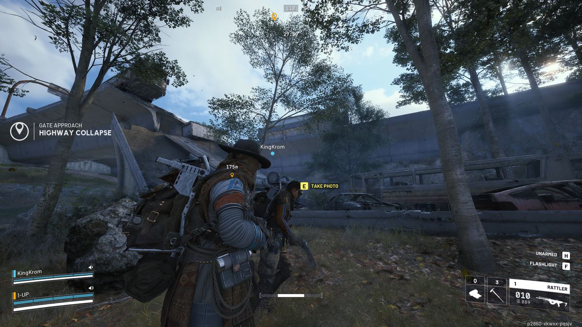 Arc Raiders Reduced to Rubble: A player about to take a photo of the collapsed highway, stood next to the highway, trees, a rock, and another player.