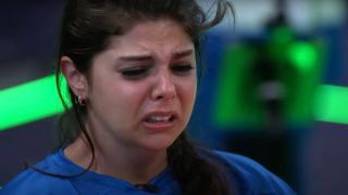 A contestant cries realizing her game is at risk.