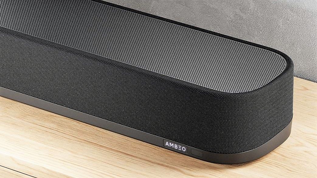 three quarter image showing Sennheiser Ambeo Soundbar Plus on wooden surface