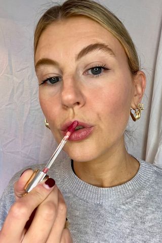 rare beauty soft pinch tinted lip oil being worn by a beauty editor