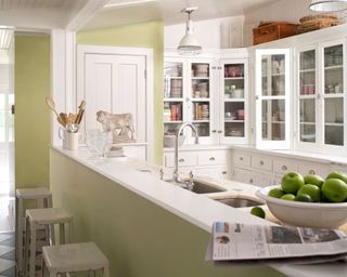 kitchen with white cabinets and lime green walls