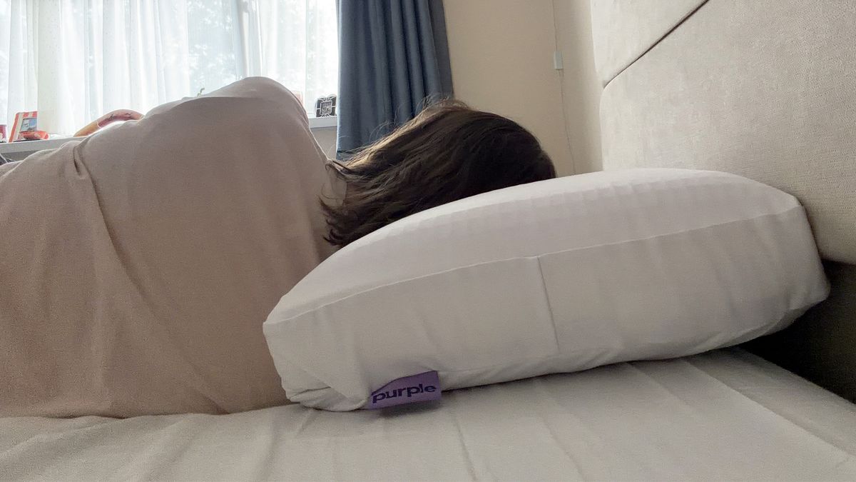 Tester Ruth Jones side sleeps on the Purple DreamLayer pillow with one booster layer