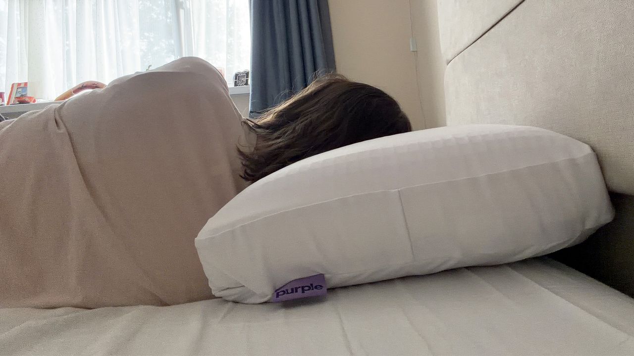 Tester Ruth Jones side sleeps on the Purple DreamLayer pillow with one booster layer