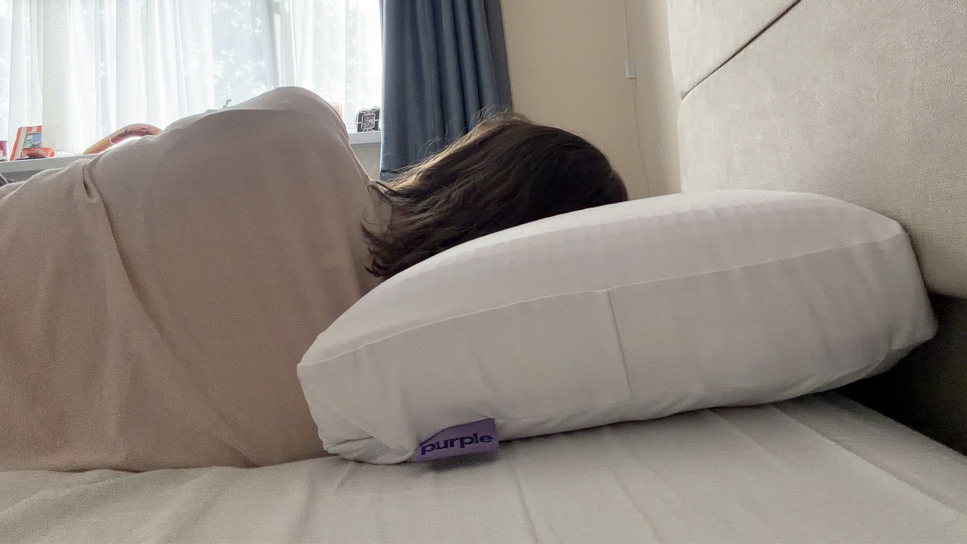 Tester Ruth Jones side sleeps on the Purple DreamLayer pillow with one booster layer