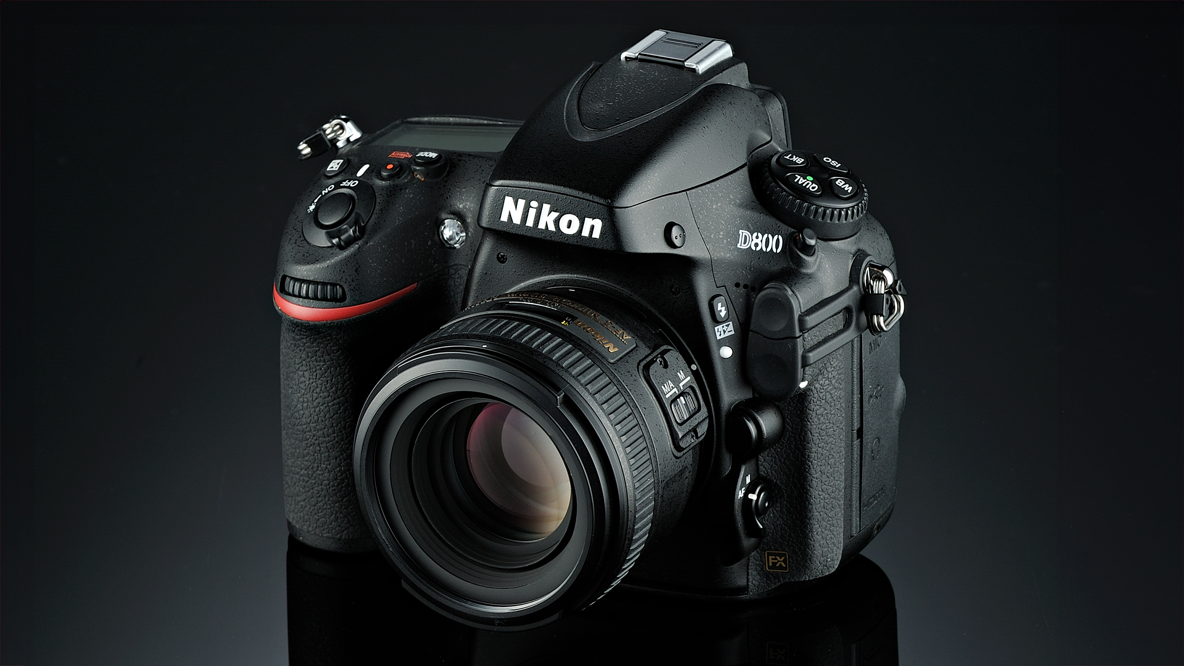 A Nikon D800 DSLR camera with a large lens, displayed against a dark background, showcasing its sleek design and features
