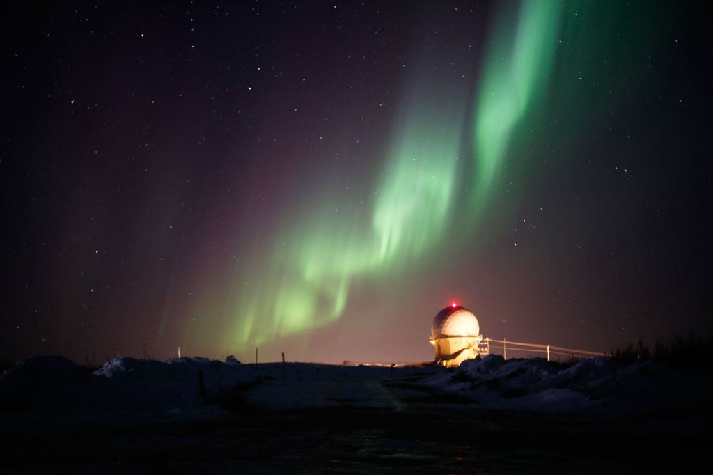 The northern lights dance above a radar facility at top of Murphy Dome mountain on April 12, 2012.