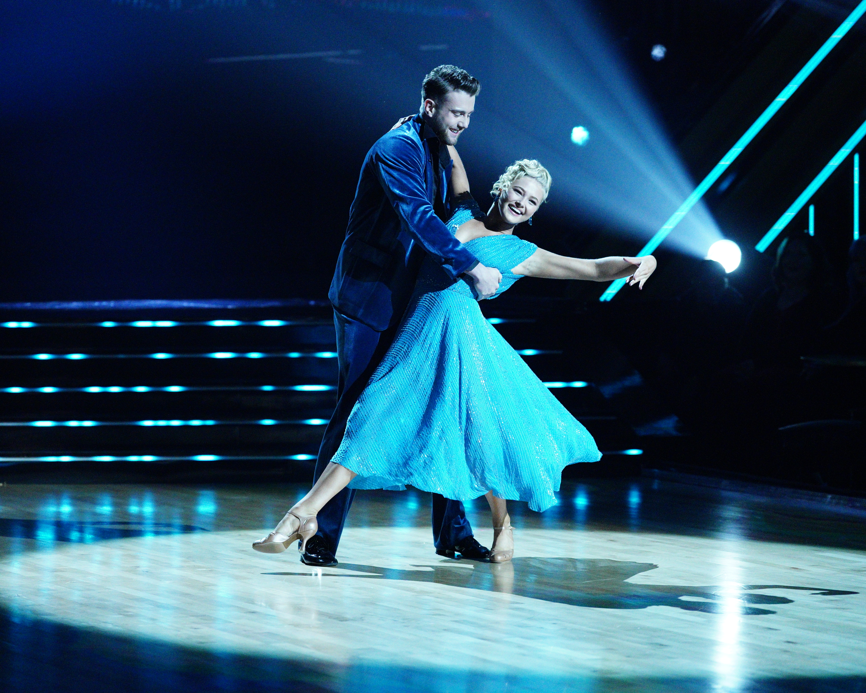 harry jowsey in a blue suit dips his dance partner in a blue dress during whitney houston night on dancing with the stars season 32