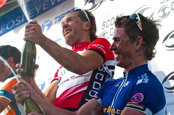 Stage winner Ben Kersten (centre) of the Swan Hill Heart of the Murray team sends the champers skyward on the podium in Red Cliffs.