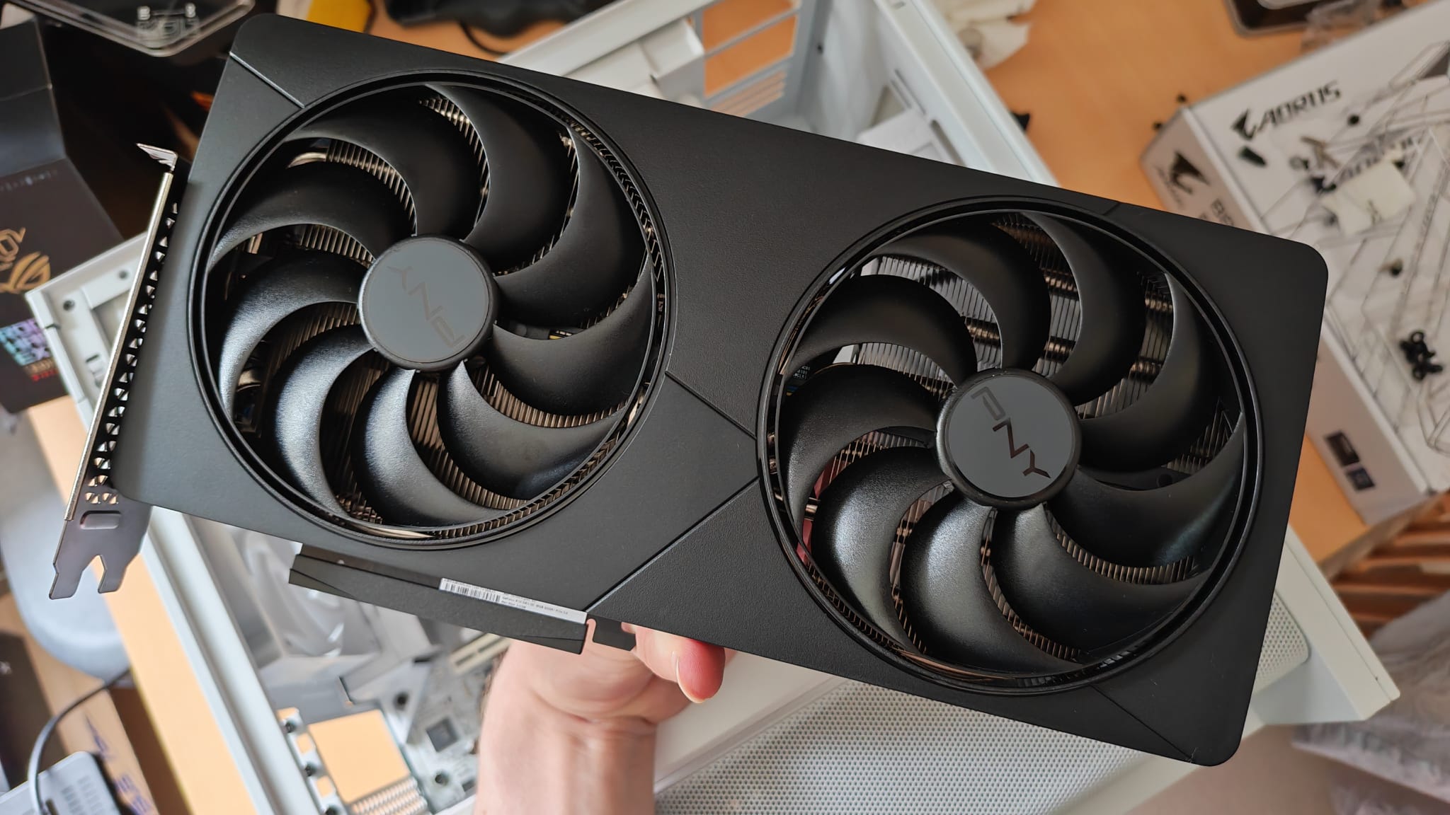 A reviewer holding the PNY GeForce RTX 5080 OC Slim in one hand