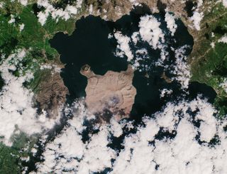 A new satellite view of the Taal volcano that erupted in the Philippines on Jan. 12 reveals an island that is now completely covered in a thick layer of ash. The eruption blasted ash plumes 9 miles (14 kilometers) into the air, and strong winds blew large amounts of ash to neighboring regions, especially the Agoncillo area, visible southwest of the Taal volcano. The European Space Agency's Copernicus Sentinel-2 mission acquired this view of the island on Thursday (Jan. 23).