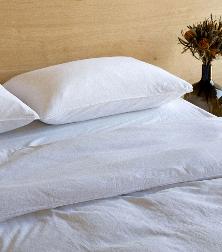 A bed with white Morrow sheets