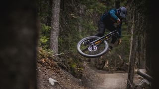 The new Kona Process X DH bike being jumped in the bike park