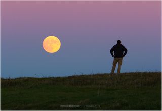 Photographer Chris Cook took a self-portrait with what he called the "super duper full moon" on Sunday (Nov. 13).