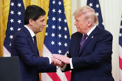 Kevin Warsh and Donald Trump shaking hands