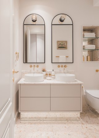 Two mirrors set over a double basin vanity.