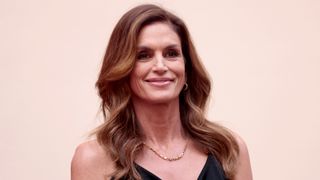 Omega Brand Ambassador Cindy Crawford is pictured with loose waves whilst attending the opening night of OMEGA House Paris 2024 on July 27, 2024 in Paris, France.