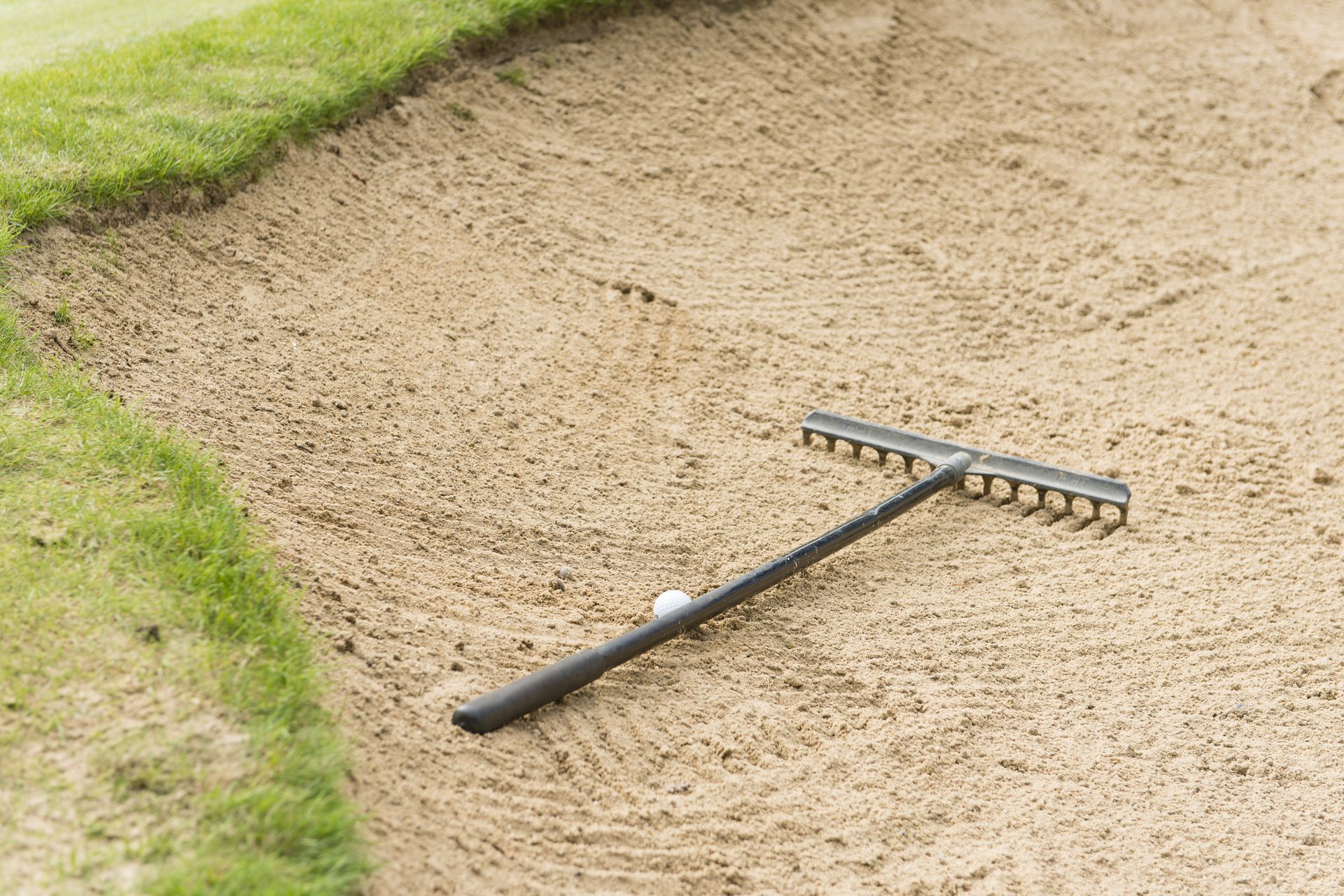 Rules Of Golf Ball Resting Against A Rake Golf Monthly